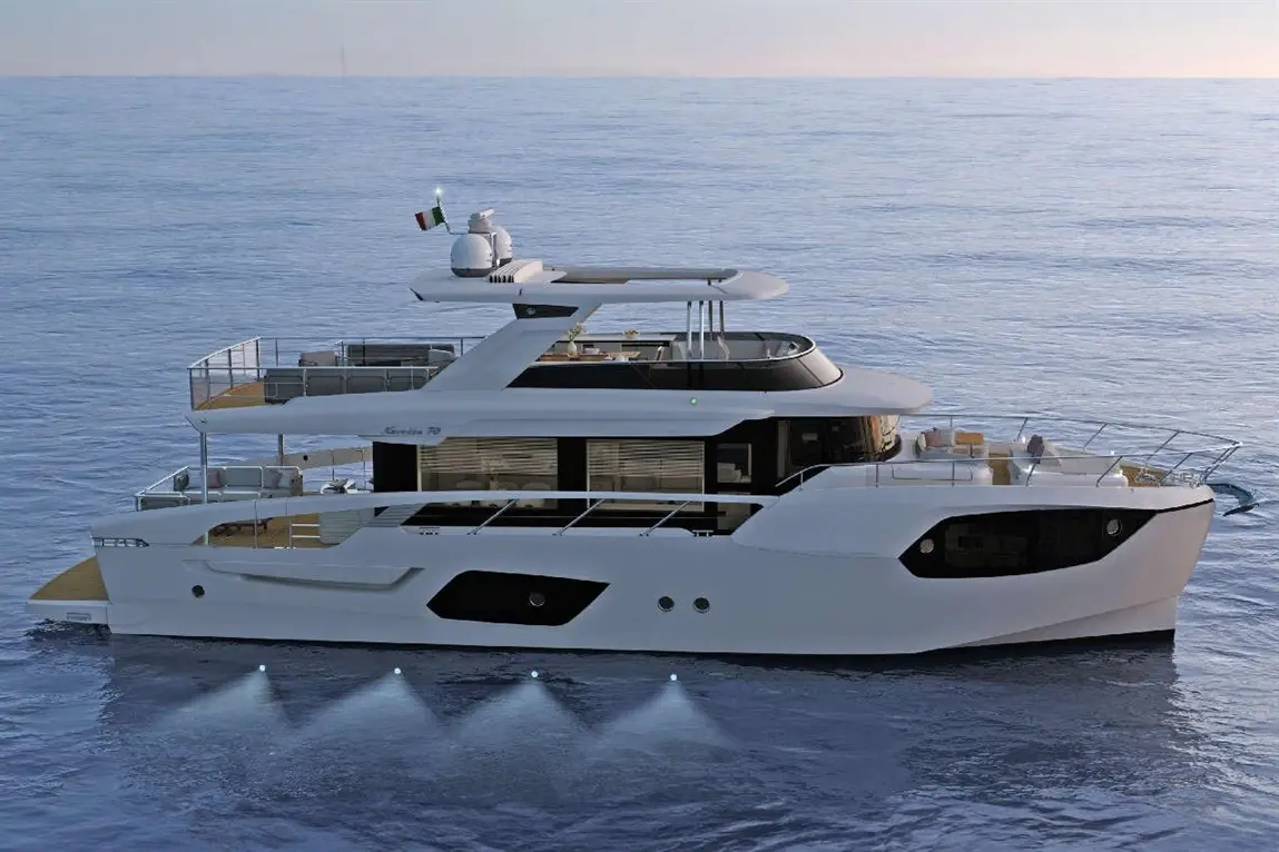 Luxury motor yacht cruising on calm waters with LED lights, featuring an Italian flag and a modern design.